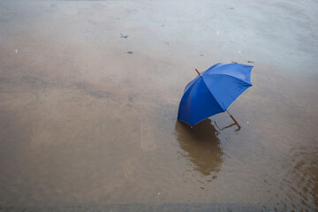 Rainy day scene urban landscape umbrella in water overcast sky aerial view serenity amidst chaos