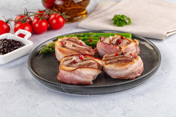 Tasty grilled pork medallion with bacon