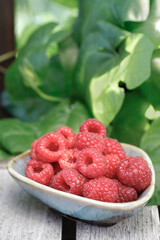Fresh raspberries in a ceramic bowl.