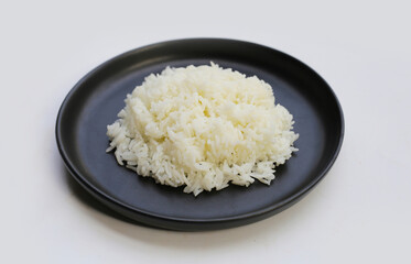 Cooked rice on black plate