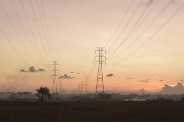 The electricity tower line with a sunset background