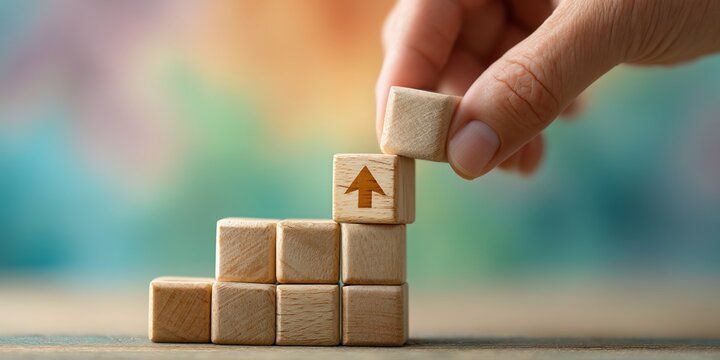 Wooden blocks forming a stairway with an upward arrow symbol, symbolizing progress and growth