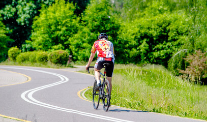 Naklejka premium Cyclist ride on the bike path in the city Park 