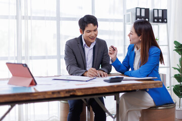 Team of Accounting business are calculating income-expenditure and analyzing real estate investment data on tablet computer, Financial and tax systems concept.
