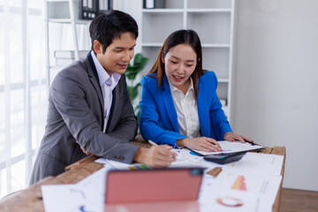 Obraz premium Team of Accounting business are calculating income-expenditure and analyzing real estate investment data on tablet computer, Financial and tax systems concept. 