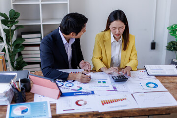Business finance accounting banking concept. Business hand doing finances and calculate on desk about cost at office. Two Business working on desk with using calculator, finance accounting.