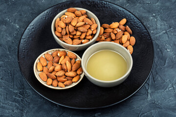 Healthy almond oil and shelled nuts.
