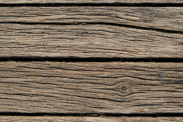 Horizontal weathered wooden planks with visible grain and texture, showcasing natural aging and rustic charm.