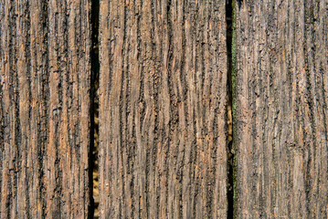 Obraz premium Vertical weathered wooden planks with visible grain and texture, showcasing natural aging and rustic charm.