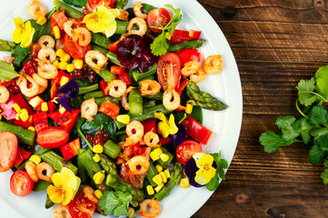 Fresh healthy shrimp salad on wooden surface, modern kitchen.