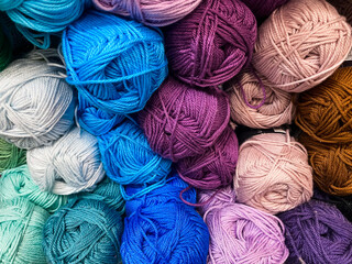Balls of multi-colored knitting threads close-up. Craft background