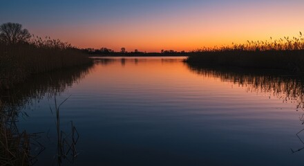 Serene Sunset over Calm Lake with Reeds