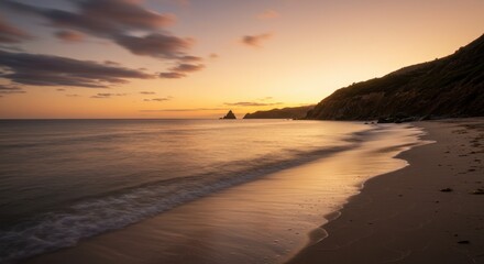 Obraz premium Serene Sunset Over Sandy Beach and Calm Ocean