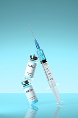 NAD+ solution in bottles for injection and syringe on on blue background. Concept of anti-aging therapy and life extension. 3d render, illustration.