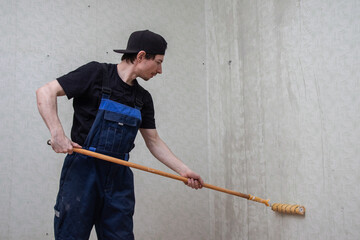 Painter wetting wallpaper with a roller (12)