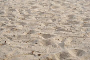 serene summer beach scene with soft sand creating gentle patterns underfoot