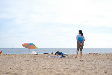 serene summer day at beach with person gazing at calm sea while enjoying warm sand underfoot