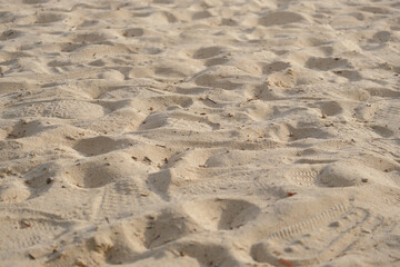 Soft sandy texture creates warm feeling of summer at beach inviting relaxation and enjoyment under...