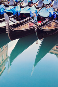 Gondola boats reflected into water, Venice, Italy