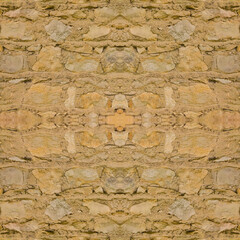 The old yellow stone wall. Yellow stone background. Stone texture. Symmetrical.