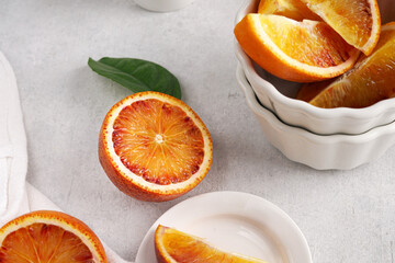 Plate with tasty blood oranges on light table
