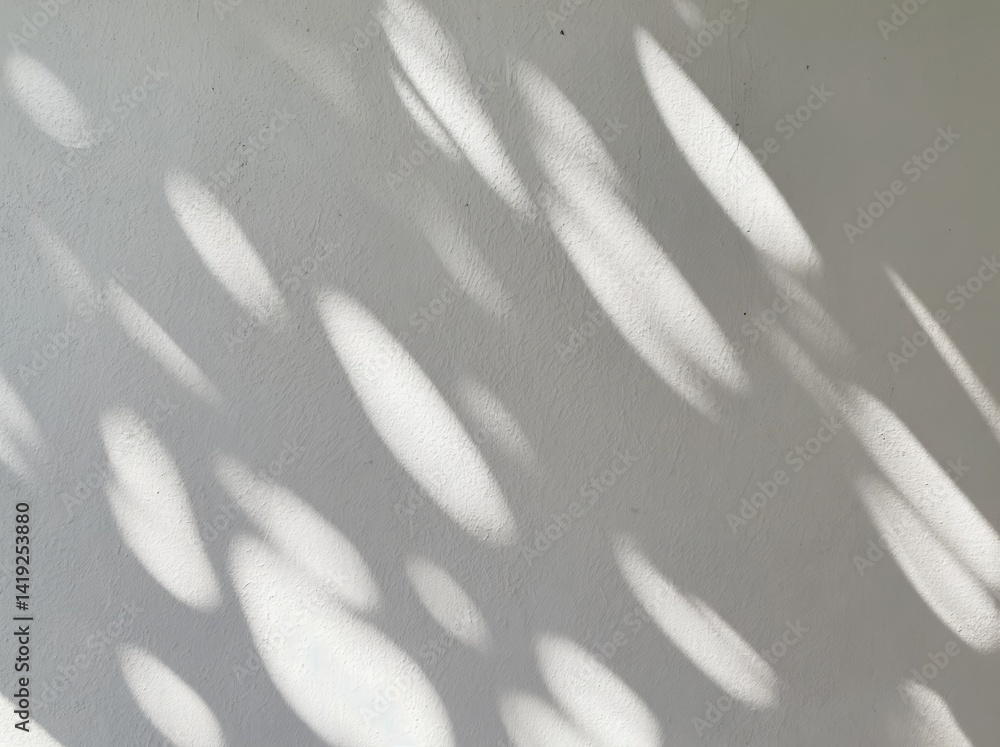 Poster soft patterns of light casting unique shapes on a textured wall creating an abstract background