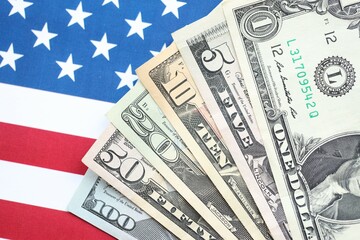 American US dollars money bills and on American flag close up
