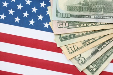 American US dollars money bills and on American flag close up