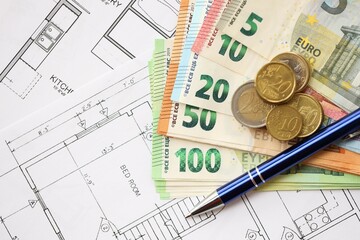 European union Euro money bills and coins with construction project blueprints on table