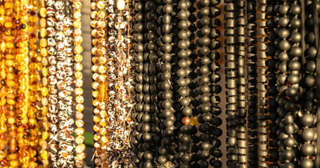 Amber stones market, polished orange gemstones closeup, natural Baltic amber gems jewelry store