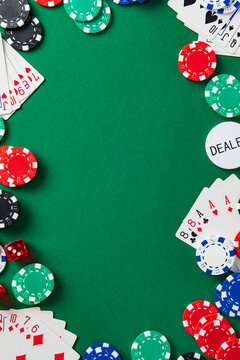 Flat lay poker table background with cards, chips, dice on green felt. Casino gambling concept with copy space for text.