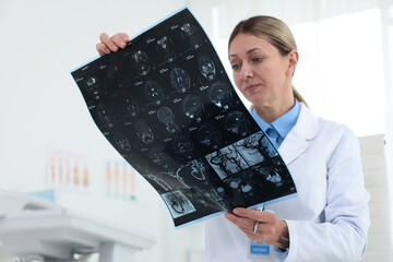 Doctor examining MRI scan in hospital, selective focus