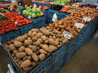 Fresh potatoes and various vegetables displayed at farmers Holesovice market in Prague, Czech republic