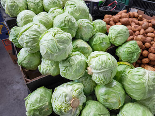Fresh green cabbages and potatoes displayed at Holesovice market stall in Prague, Czech republic