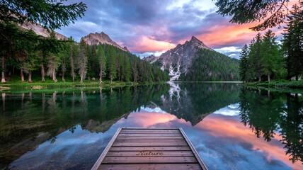 Obraz premium Explore the serene beauty of lake braies italy dolomites mountains and forest at sunset for travel inspiration