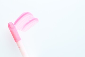 Moisturizing lip balm and applicator on white background, top view. Space for text