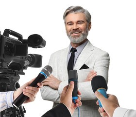 Journalists with microphones and video camera interviewing man on white background, closeup
