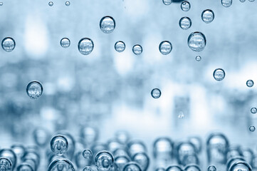 Soda water with bubbles in glass, closeup