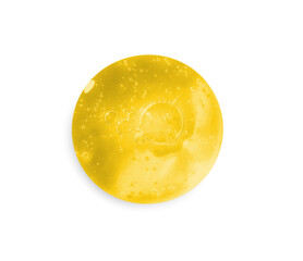 Drop of golden serum on white background