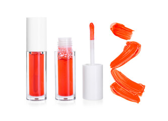Tubes of lip gloss, applicator and samples isolated on white