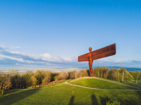 Gateshead UK: 13th April 2025: Dawn light illuminating the Angel of the North sculpture by artist Antony Gormley, in Gateshead with vibrant colours and copy space