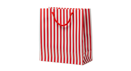 A red and white striped shopping bag with red rope handles on a black background in a studio shot