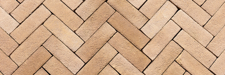 Panoramic image. New small rectangular paving stones on the sidewalk