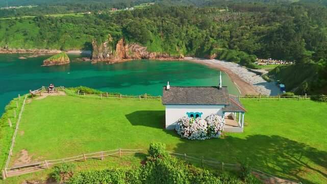 Aerial view of a Ermita de la Regalina on the steep cliffs in Asturias, Spain
