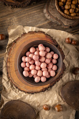 Bowl of raspberry flavour white chocolate covered hazelnuts