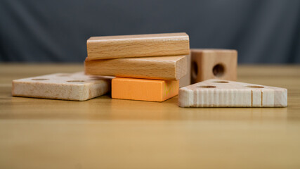 A creative arrangement of wooden blocks of various shapes and sizes, showcasing natural wood textures and colors. Perfect for educational, architectural, or design concepts.