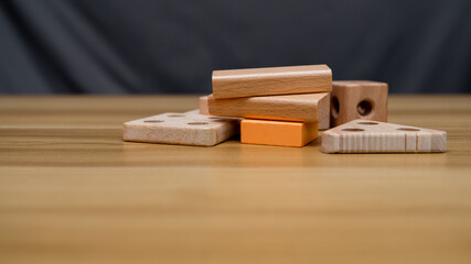 A creative arrangement of wooden blocks of various shapes and sizes, showcasing natural wood textures and colors. Perfect for educational, architectural, or design concepts.