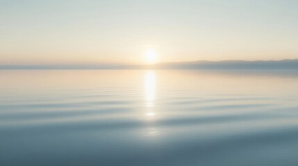 Obraz premium Peaceful sunrise over a calm lake, bathed in pale light.
