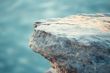 Fototapeta premium Natural stone formation by water edge reflecting tranquility and resilience in nature concept