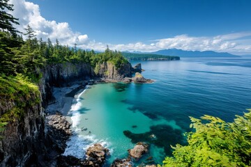 Obraz premium Turquoise water lapping secluded beach on rugged coastline with lush forest